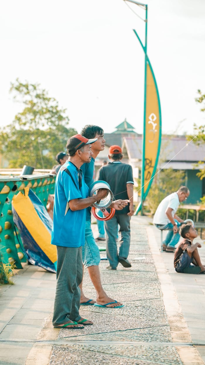 A group of people standing on a bridge with surfboards